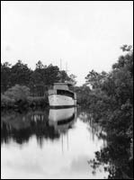 A ship slowly moving down the Manatee River.<br/>Credit: Burgert Brothers Photograph Collection - USF Special Collections.